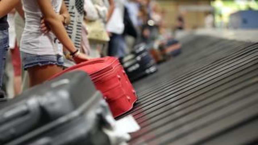 Bigstock-Suitcase-on-luggage-conveyor-b-50936357