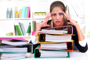 Bigstock-tired-business-woman-with-docu-38920228-300x200